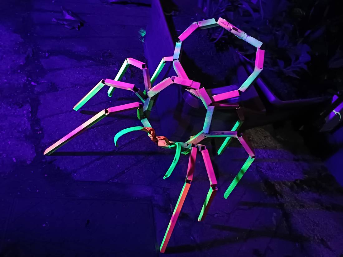 Spider in coloured rope and steel under UV