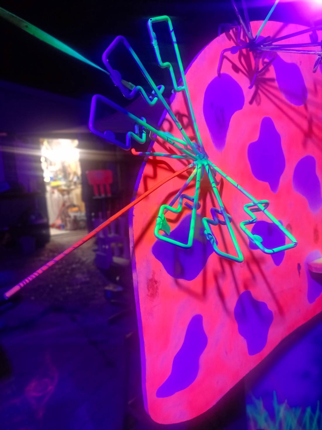 Wall-mounted piece against a UV painted backdrop